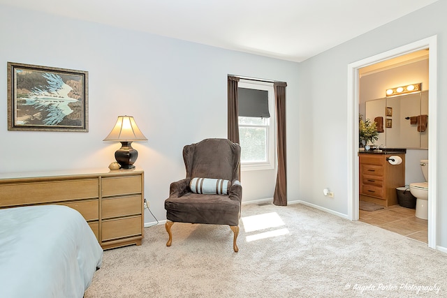 carpeted bedroom featuring ensuite bath