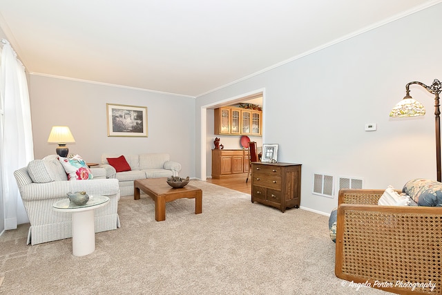 carpeted living room with ornamental molding