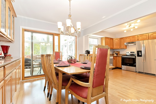 dining space with an inviting chandelier, light wood-type flooring, and ornamental molding