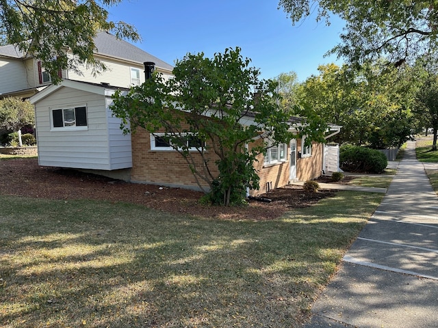 view of side of home featuring a yard