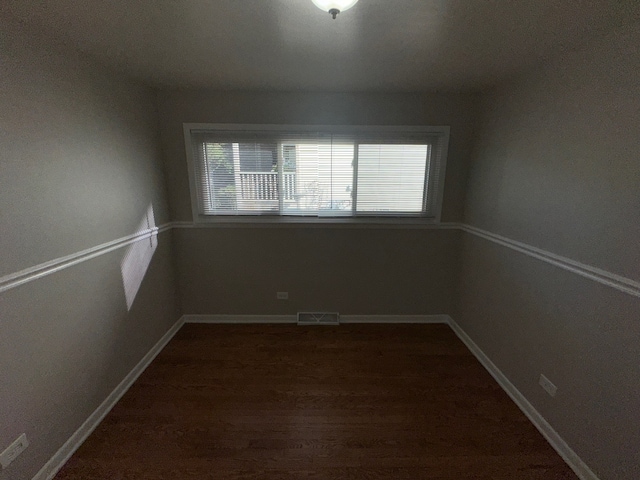 spare room featuring dark hardwood / wood-style flooring