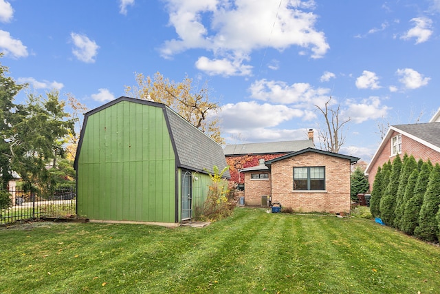 exterior space featuring a lawn and an outdoor structure