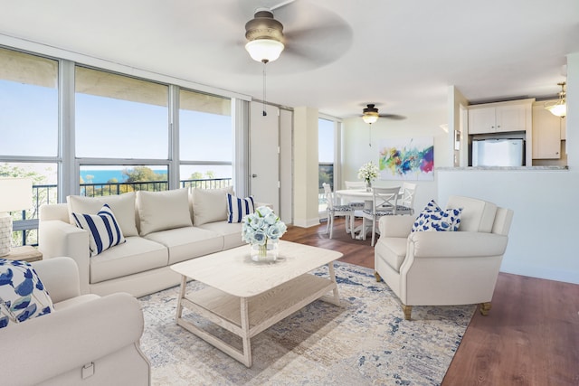 living room with hardwood / wood-style flooring, floor to ceiling windows, and ceiling fan