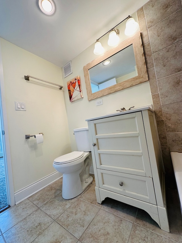 bathroom featuring toilet, vanity, and tile patterned floors