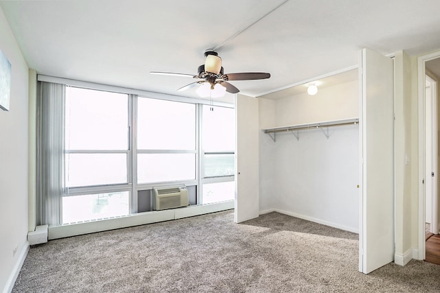 unfurnished bedroom with a closet, ceiling fan, cooling unit, and carpet floors