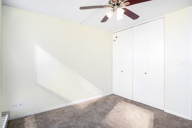 unfurnished bedroom featuring carpet flooring, a closet, and ceiling fan