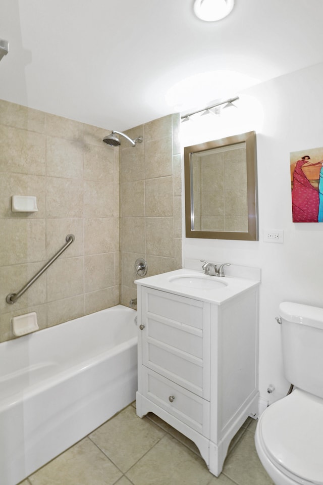 full bathroom featuring vanity, toilet, tiled shower / bath combo, and tile patterned flooring