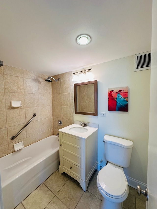 full bathroom featuring tiled shower / bath, vanity, toilet, and tile patterned floors