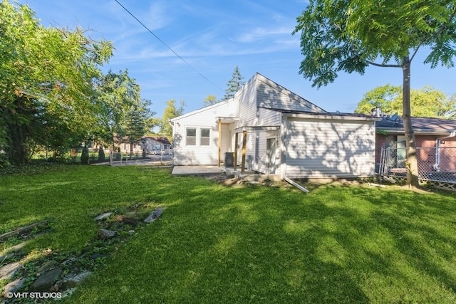 back of property featuring a patio and a yard