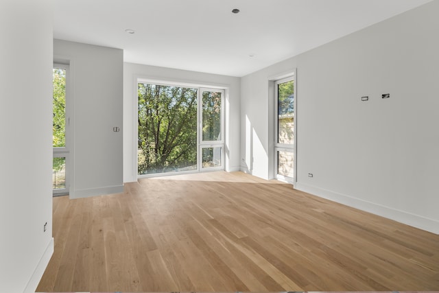 unfurnished room with light hardwood / wood-style floors