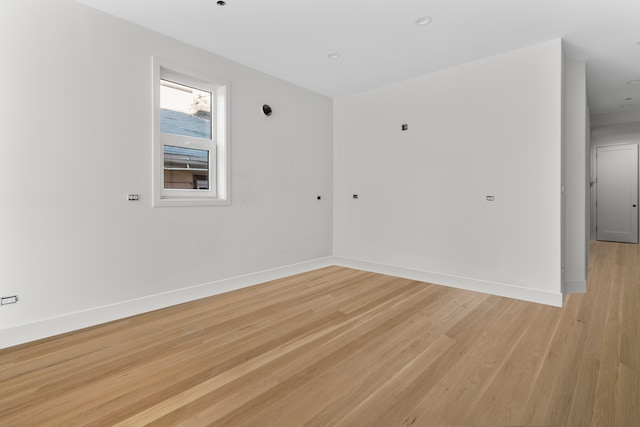 spare room with light hardwood / wood-style flooring