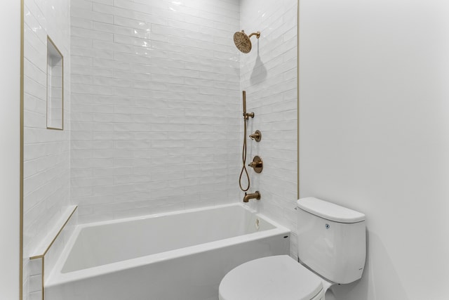 bathroom with tiled shower / bath combo and toilet