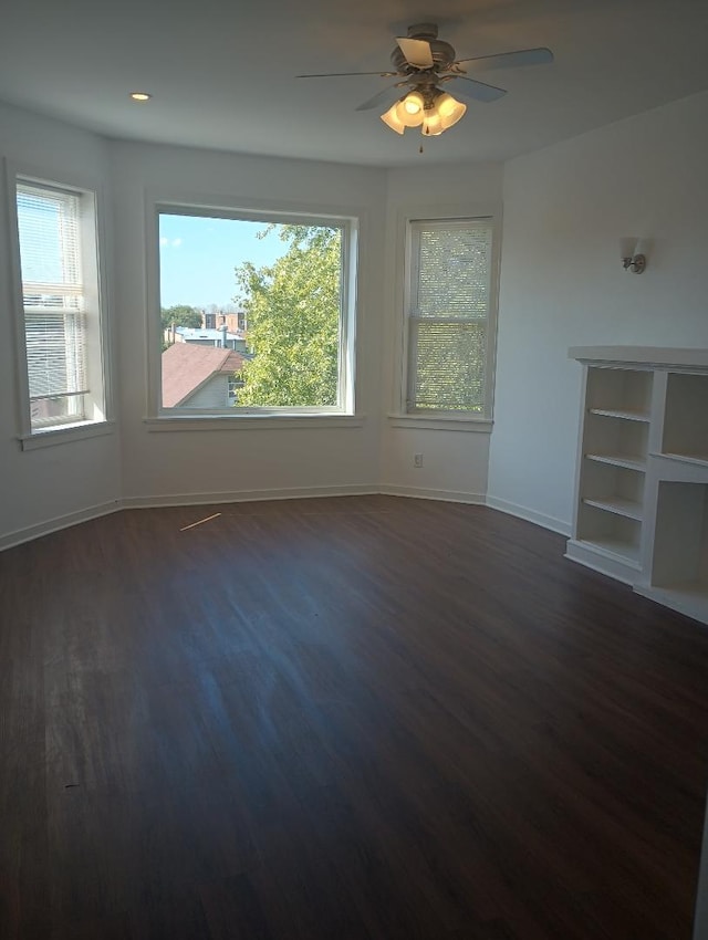 interior space with dark wood-type flooring and ceiling fan