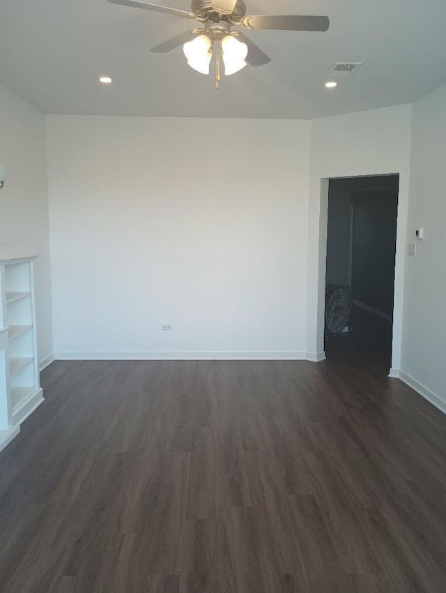 empty room featuring ceiling fan and dark hardwood / wood-style flooring