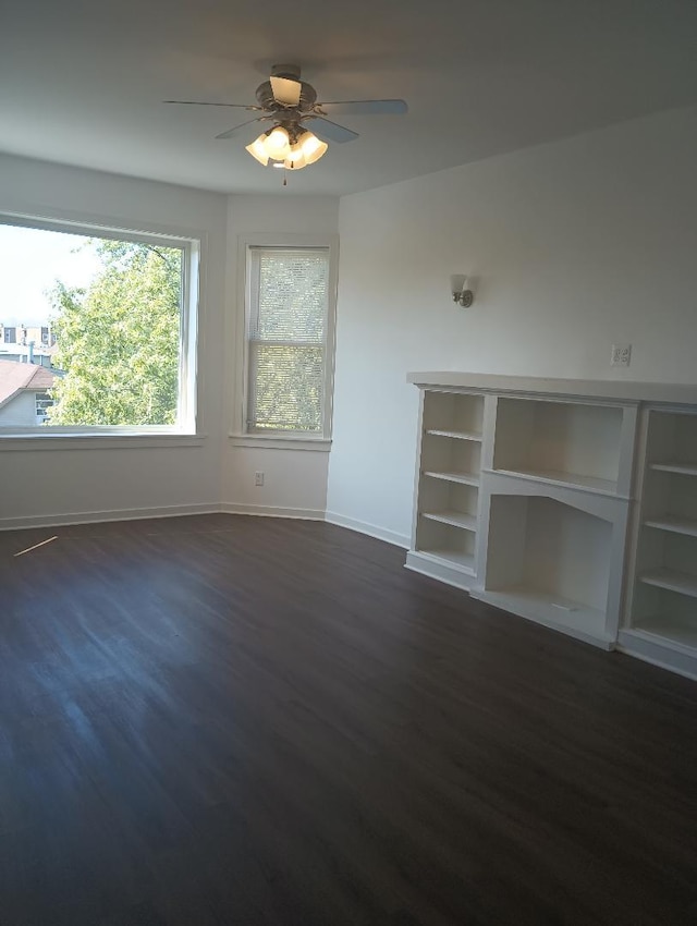 interior space with dark wood-type flooring and ceiling fan