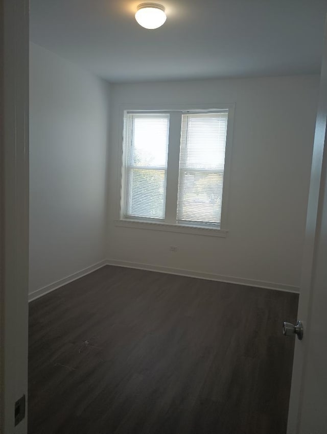 unfurnished room featuring dark hardwood / wood-style floors