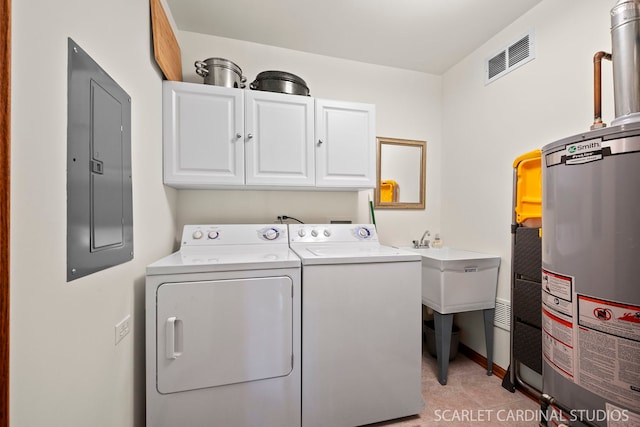 washroom with washing machine and clothes dryer, cabinets, water heater, electric panel, and light tile patterned floors