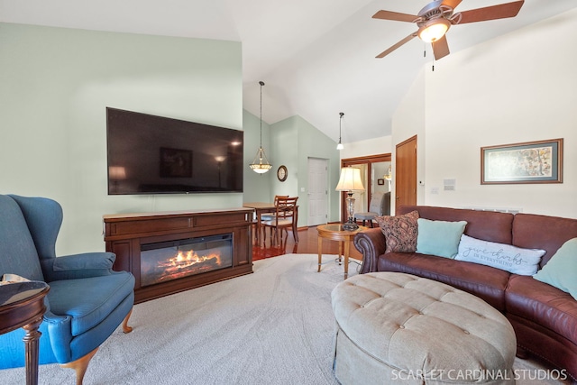 living room featuring ceiling fan and lofted ceiling