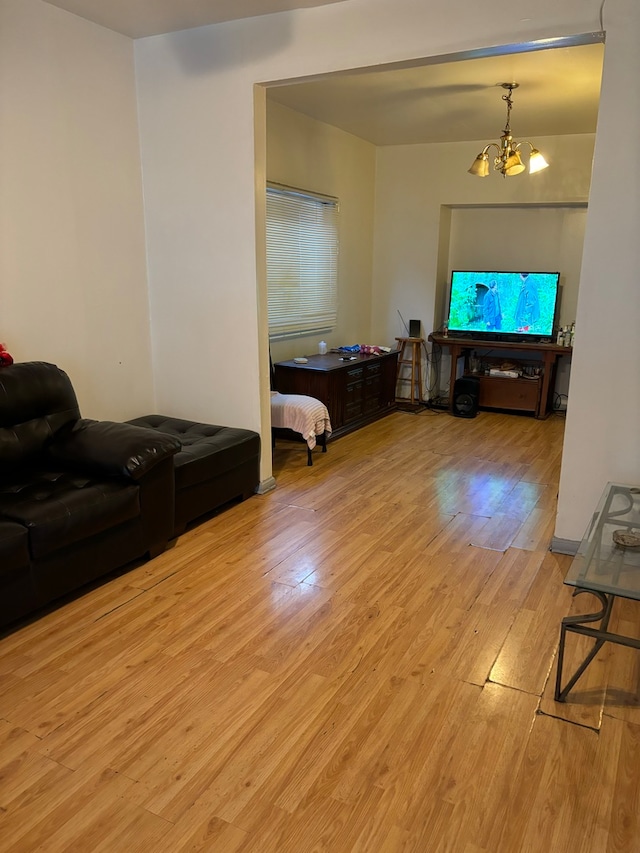 living room with a chandelier and light hardwood / wood-style floors