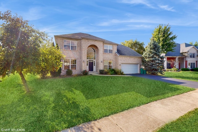 view of front property with a garage and a front lawn