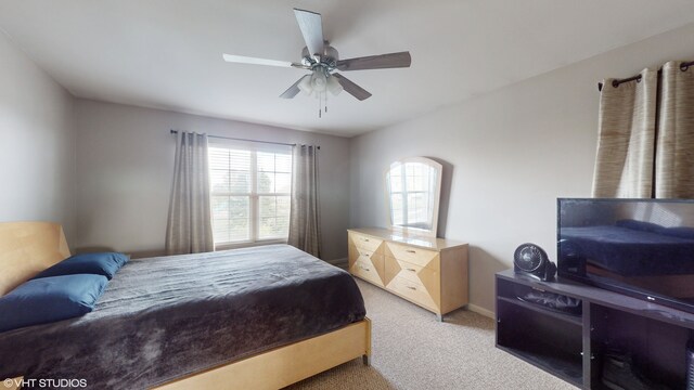 bedroom featuring ceiling fan and light carpet