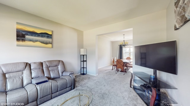 carpeted living room featuring a chandelier