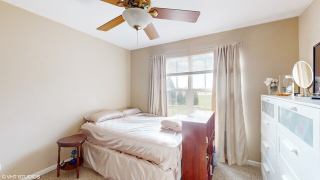 bedroom featuring light carpet and ceiling fan