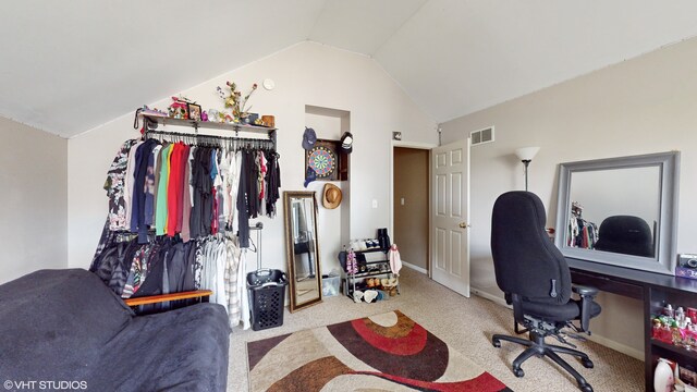 carpeted office space with vaulted ceiling