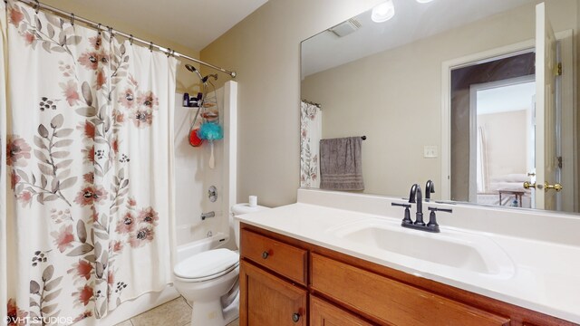 full bathroom featuring tile patterned flooring, shower / tub combo, vanity, and toilet