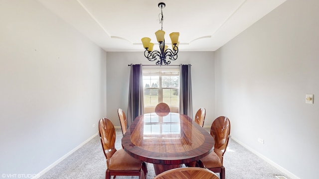 carpeted dining space featuring a notable chandelier