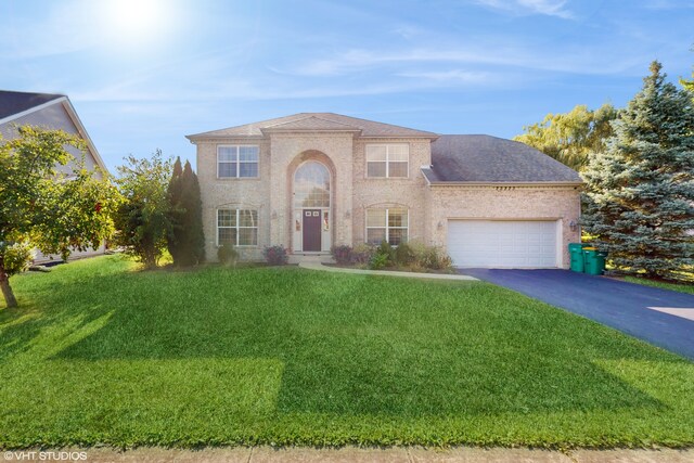 view of front of property with a front yard and a garage