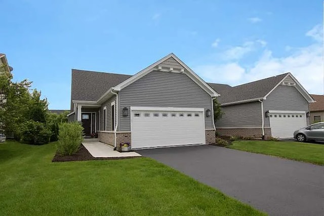 view of front of property featuring a front yard and a garage