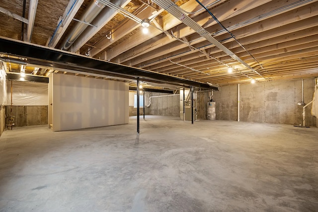 basement featuring water heater and heating unit