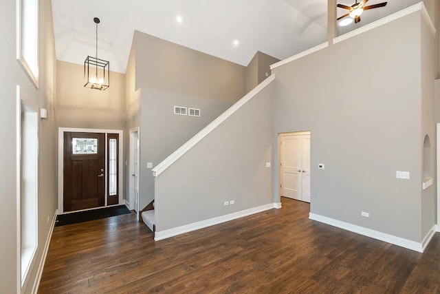 entryway with dark hardwood / wood-style floors, a high ceiling, and ceiling fan