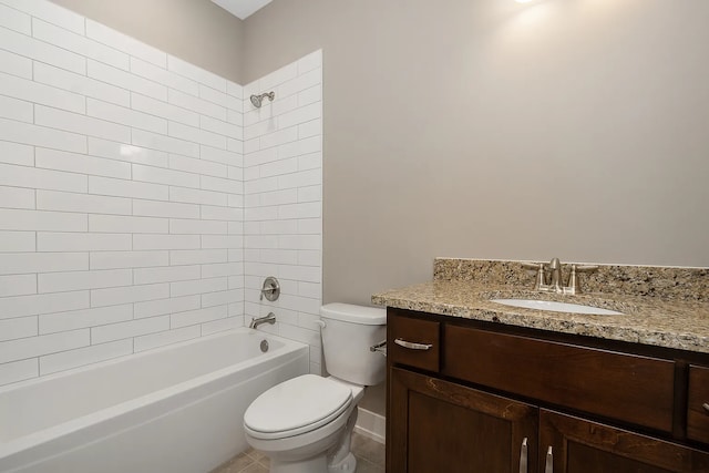 full bathroom with tiled shower / bath, vanity, toilet, and tile patterned floors