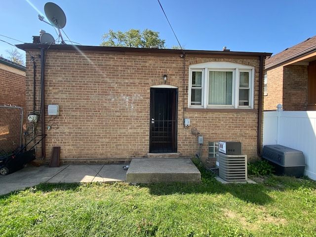 exterior space featuring central AC and a lawn