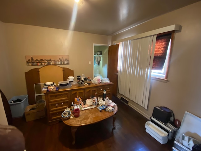 home office with dark hardwood / wood-style flooring