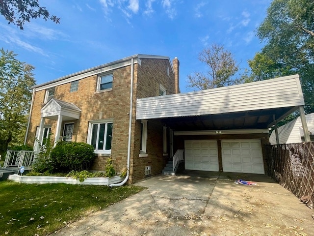 view of front of house with a garage and a carport