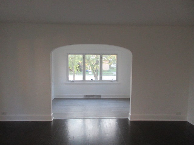 empty room featuring dark wood-type flooring