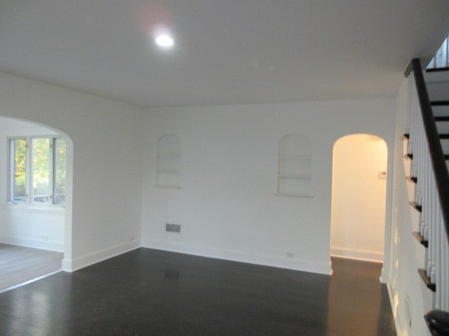 empty room with dark hardwood / wood-style flooring