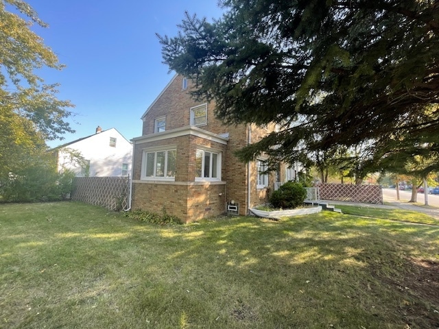 view of home's exterior with a lawn