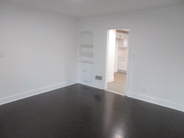 spare room with wood-type flooring