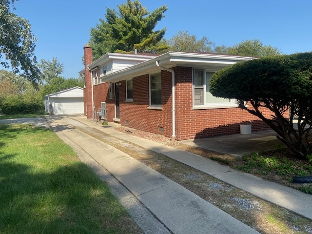 view of side of property with a garage and an outbuilding