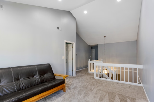 sitting room with lofted ceiling and light carpet