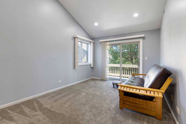 living area featuring vaulted ceiling and carpet