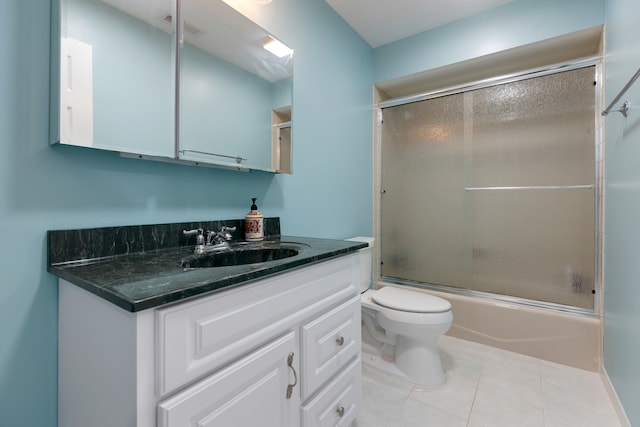 full bathroom featuring vanity, tile patterned flooring, toilet, and combined bath / shower with glass door