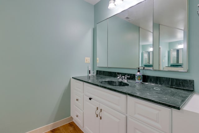 bathroom featuring hardwood / wood-style floors and vanity