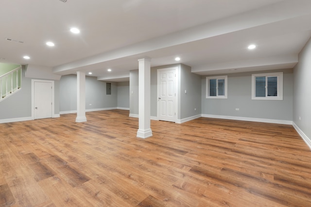 basement with electric panel and light wood-type flooring