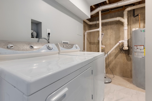 laundry room with electric water heater and separate washer and dryer