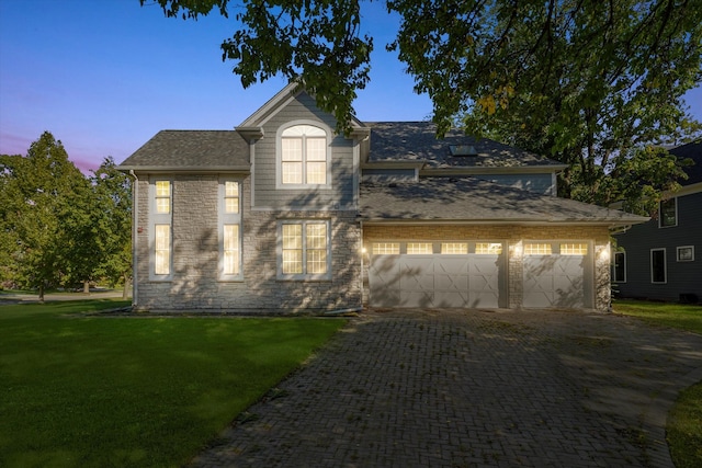 view of front of property featuring a yard and a garage